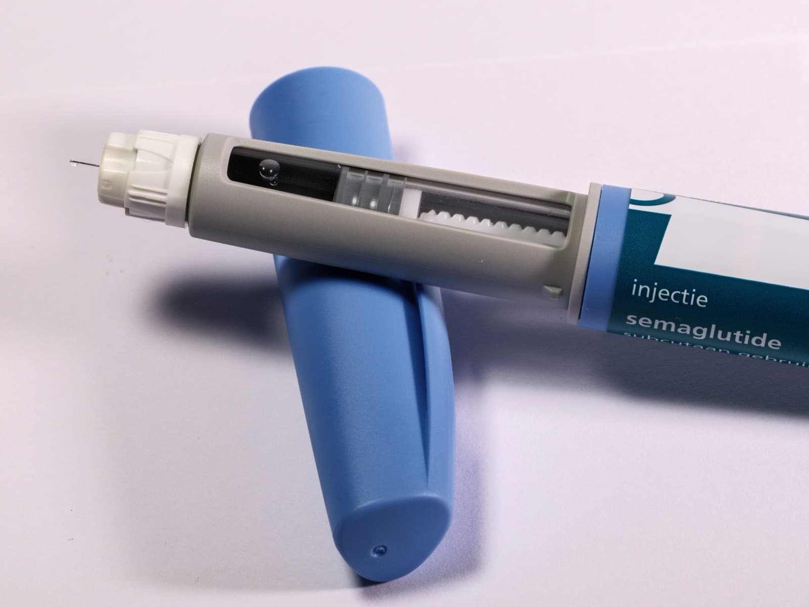 Close-up of a semaglutide injection pen, the drug class behind Wegovy, resting on a table