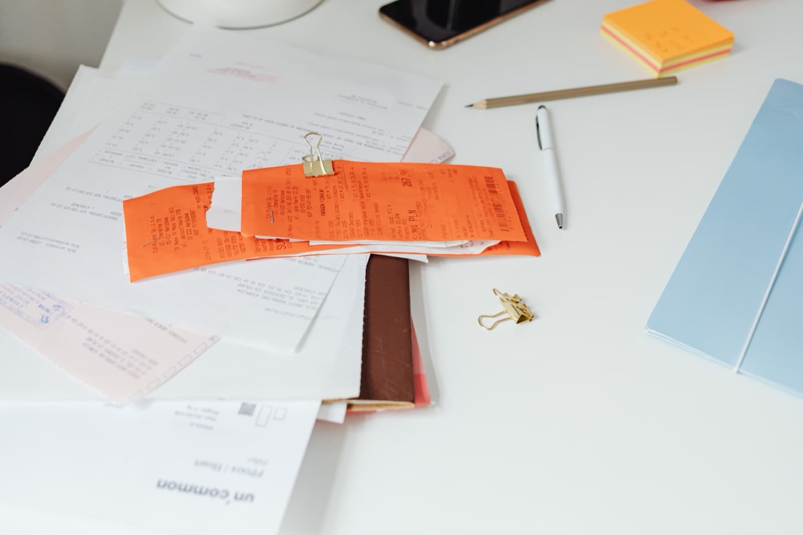 A tidy desk covered in receipts and paperwork, representing the volume of prior authorization requests insurers process each year