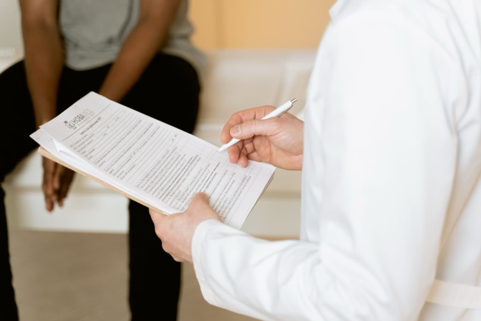 A healthcare professional reviewing a medical form during a consultation, part of the prior authorization process